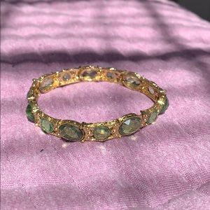 Gold bracelet with green gems